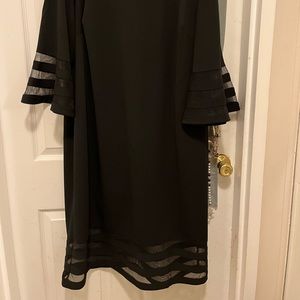 Black dress with net trim on bell sleeves and hem